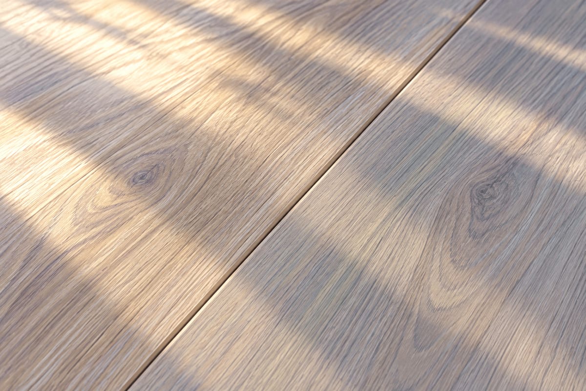 Close view of dry seams between wood-look floor planks.